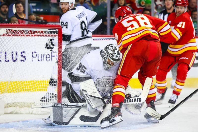 Nov 11, 2024; Calgary, Alberta, CAN; Los Angeles Kings goaltender Darcy Kuemper (35) makes a save against Calgary Flames center Justin Kirkland (58) during the second period at Scotiabank Saddledome. Mandatory Credit: Sergei Belski-Imagn Images