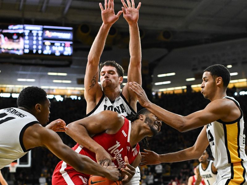 Mar 5, 2023; Iowa City, Iowa, USA; Nebraska Cornhuskers forward Derrick Walker (13) has the ball stripped away by Iowa Hawkeyes guard Tony Perkins (11) as forward Kris Murray (24) and forward Filip Rebraca (0) defend during the first half at Carver-Hawkeye Arena. Mandatory Credit: Jeffrey Becker-USA TODAY Sports