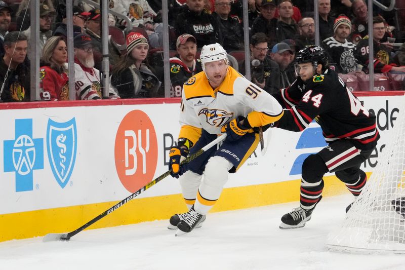 Nov 28, 2025; Chicago, Illinois, USA;  Nashville Predators center Steven Stamkos (91) controls the puck against Chicago Blackhawks defenseman Wyatt Kaiser (44) during the first period at United Center. Mandatory Credit: David Banks-Imagn Images