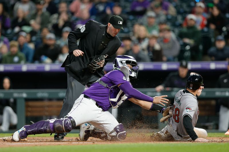 Apr 8, 2024; Denver, Colorado, USA; Arizona Diamondbacks shortstop Kevin Newman (18) scores on a play ahead of the tag from Colorado Rockies catcher Elias Diaz (35) as umpire Nic Lentz (59) looks on in the fourth inning at Coors Field. Mandatory Credit: Isaiah J. Downing-USA TODAY Sports