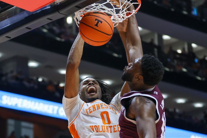 Feb 24, 2024; Knoxville, Tennessee, USA; Tennessee Volunteers forward Jonas Aidoo (0) dunks the ball against Texas A&M Aggies forward Wildens Leveque (10) during the second half at Thompson-Boling Arena at Food City Center. Mandatory Credit: Randy Sartin-USA TODAY Sports