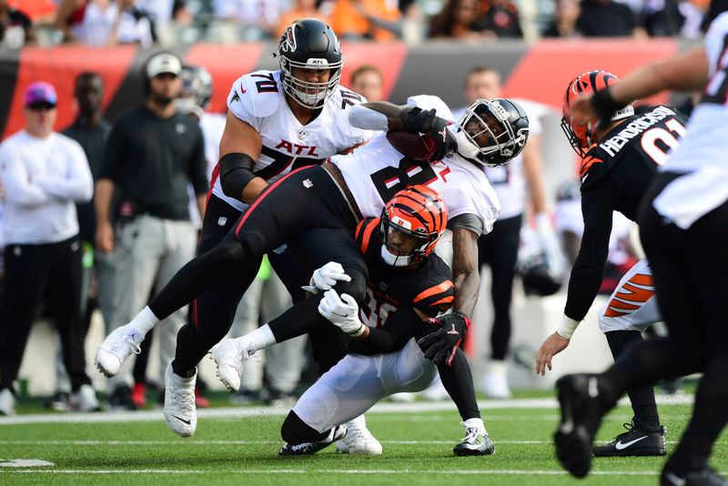 Atlanta Falcons tight end Kyle Pitts (8) is tackled by Cincinnati Bengals safety Jessie Bates III (30) during an NFL football game, Sunday, Oct. 23, 2022, in Cincinnati. (AP Photo/Emilee Chinn)