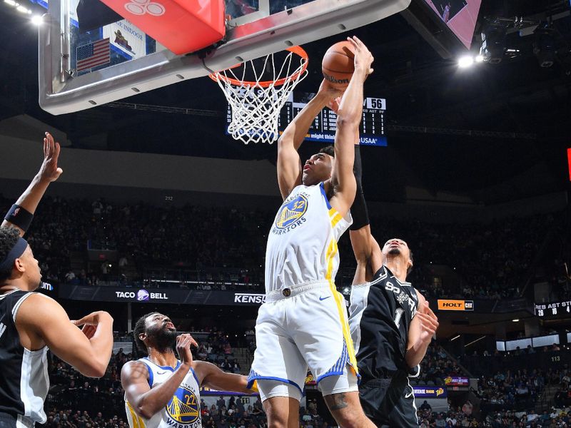 SAN ANTONIO, TX - MARCH 11:  Trayce Jackson-Davis #32 of the Golden State Warriors  drives to the basket during the game as Victor Wembanyama #1 of the San Antonio Spurs plays defense on March 11, 2024 at the Frost Bank Center in San Antonio, Texas. NOTE TO USER: User expressly acknowledges and agrees that, by downloading and or using this photograph, user is consenting to the terms and conditions of the Getty Images License Agreement. Mandatory Copyright Notice: Copyright 2024 NBAE (Photos by Michael Gonzales/NBAE via Getty Images)