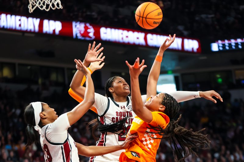 Mar 3, 2024; Columbia, South Carolina, USA; South Carolina Gamecocks guard Bree Hall (23) and forward Sania Feagin (20) battle Tennessee Lady Vols guard Jewel Spear (0) for a rebound in the second half at Colonial Life Arena. Mandatory Credit: Jeff Blake-USA TODAY Sports