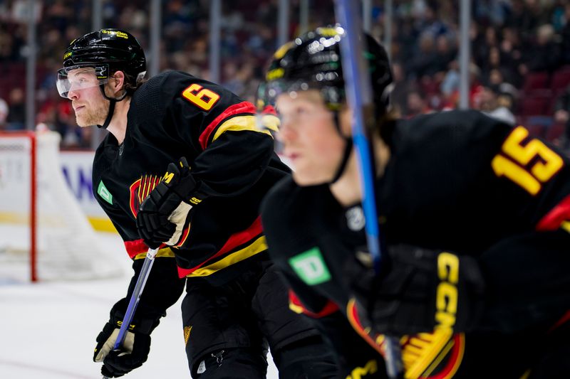 Feb 13, 2023; Vancouver, British Columbia, CAN; Vancouver Canucks forward Brock Boeser (6) and forward Sheldon Dries (15) skate up ice against the Detroit Red Wings in the third period at Rogers Arena. Red Wings won 6-1. Mandatory Credit: Bob Frid-USA TODAY Sports