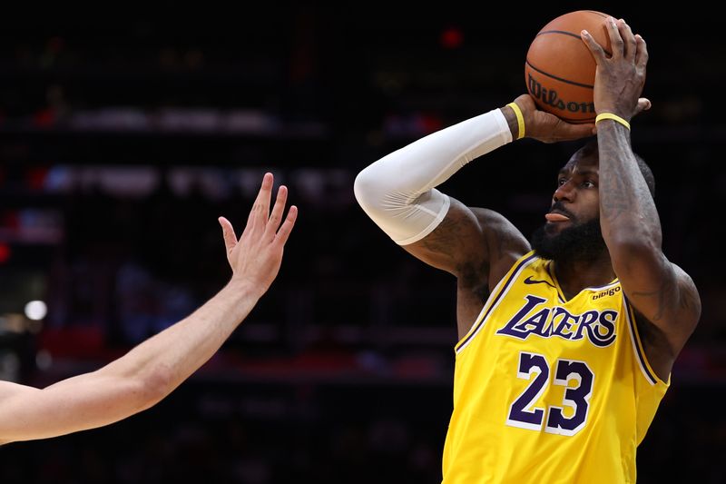 WASHINGTON, DC - APRIL 03: LeBron James #23 of the Los Angeles Lakers shoots against the Washington Wizards during the second half at Capital One Arena on April 03, 2024 in Washington, DC. NOTE TO USER: User expressly acknowledges and agrees that, by downloading and or using this photograph, User is consenting to the terms and conditions of the Getty Images License Agreement. (Photo by Patrick Smith/Getty Images)