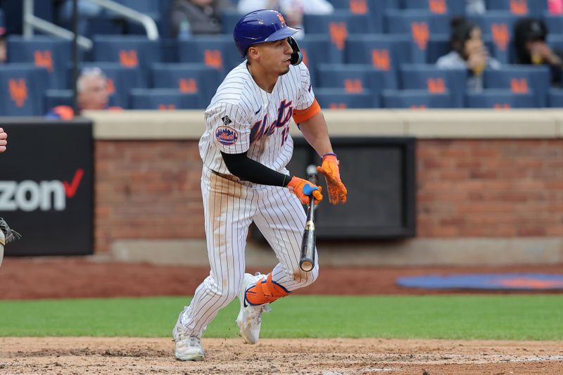 Apr 17, 2024; New York City, New York, USA; New York Mets right fielder Tyrone Taylor (15) follows through on a two run single against the Pittsburgh Pirates during the sixth inning at Citi Field. Mandatory Credit: Brad Penner-USA TODAY Sports