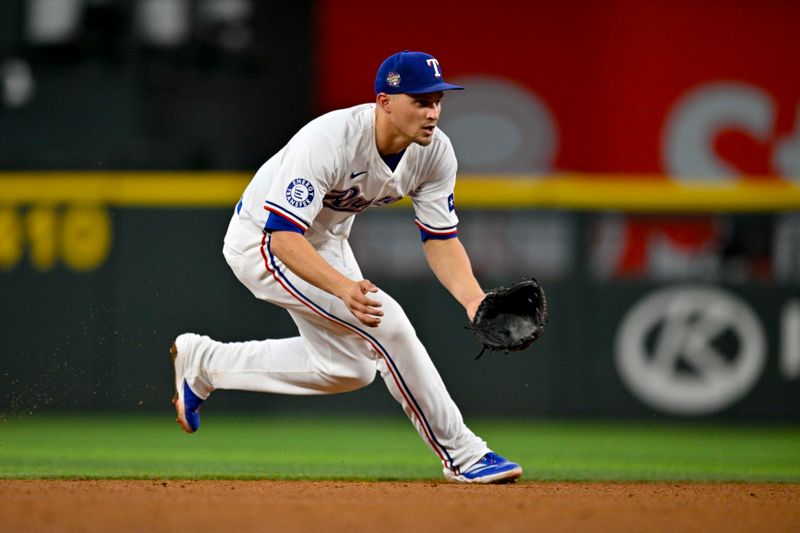 Apr 27, 2024; Arlington, Texas, USA; Texas Rangers shortstop Corey Seager (5) fields a ball and throws to first base during the sixth inning against the Cincinnati Reds at Globe Life Field. Mandatory Credit: Jerome Miron-USA TODAY Sports