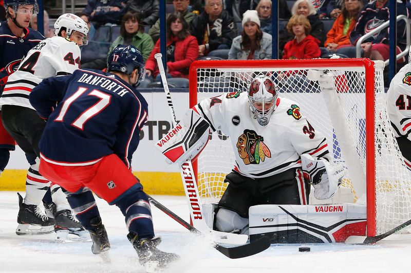 Nov 22, 2023; Columbus, Ohio, USA; Chicago Blackhawks goalie Petr Mrazek (34) makes a save from the shot of Columbus Blue Jackets right wing Justin Danforth (17) during the first period at Nationwide Arena. Mandatory Credit: Russell LaBounty-USA TODAY Sports