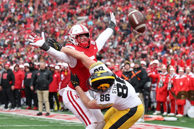 Nov 24, 2023; Lincoln, Nebraska, USA; Nebraska Cornhuskers linebacker John Bullock (5) defends the pass on Iowa Hawkeyes tight end Steven Stilianos (86) at Memorial Stadium. Mandatory Credit: Reese Strickland-USA TODAY Sports