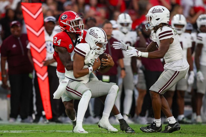 Oct 12, 2024; Athens, Georgia, USA; Georgia Bulldogs defensive back Malaki Starks (24) tackles Mississippi State Bulldogs quarterback Michael Van Buren Jr. (0) in the third quarter at Sanford Stadium. Mandatory Credit: Brett Davis-Imagn Images
