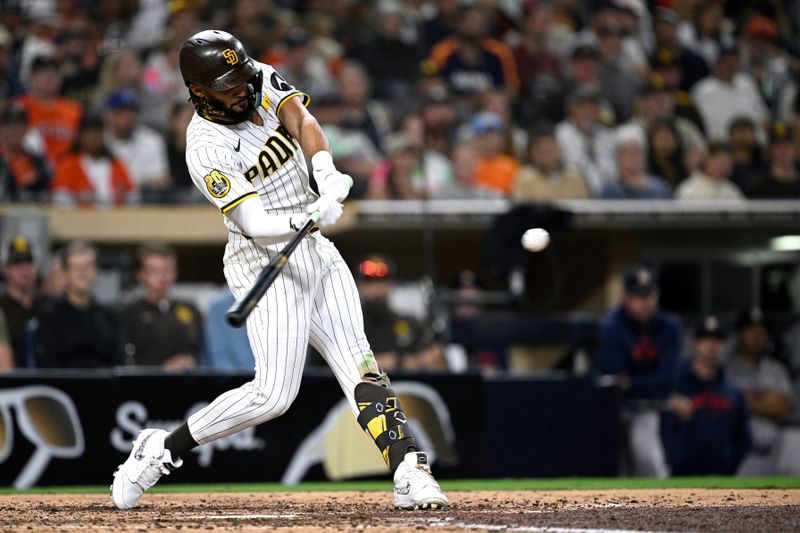 Sep 17, 2024; San Diego, California, USA; San Diego Padres right fielder Fernando Tatis Jr. (23) hits a double against the Houston Astros during the eighth inning at Petco Park. Mandatory Credit: Orlando Ramirez-Imagn Images