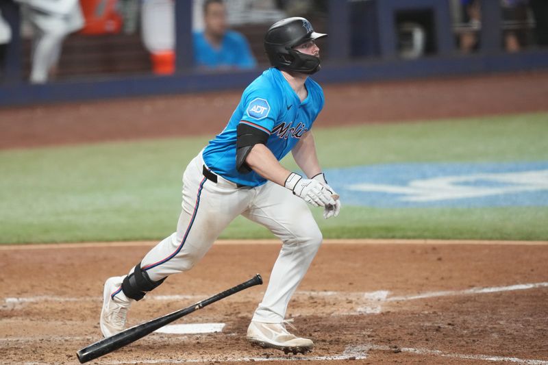May 18, 2025; Miami, Florida, USA;  Miami Marlins catcher Liam Hicks (34) hits a two-run home run in the sixth inning against the Tampa Bay Rays at loanDepot Park. Mandatory Credit: Jim Rassol-Imagn Images