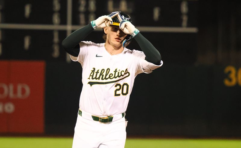 Jun 19, 2024; Oakland, California, USA; Oakland Athletics second baseman Zack Gelof (20) gestures as he rounds the bases on a solo home run against the Kansas City Royals during the eighth inning at Oakland-Alameda County Coliseum. Mandatory Credit: Kelley L Cox-USA TODAY Sports