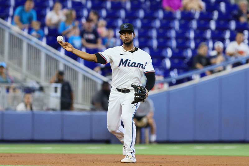 Apr 17, 2024; Miami, Florida, USA; Miami Marlins third baseman Otto Lopez (61) throws to first base and retires San Francisco Giants first baseman Wilmer Flores (not pictured) during the first inning at loanDepot Park. Mandatory Credit: Sam Navarro-USA TODAY Sports