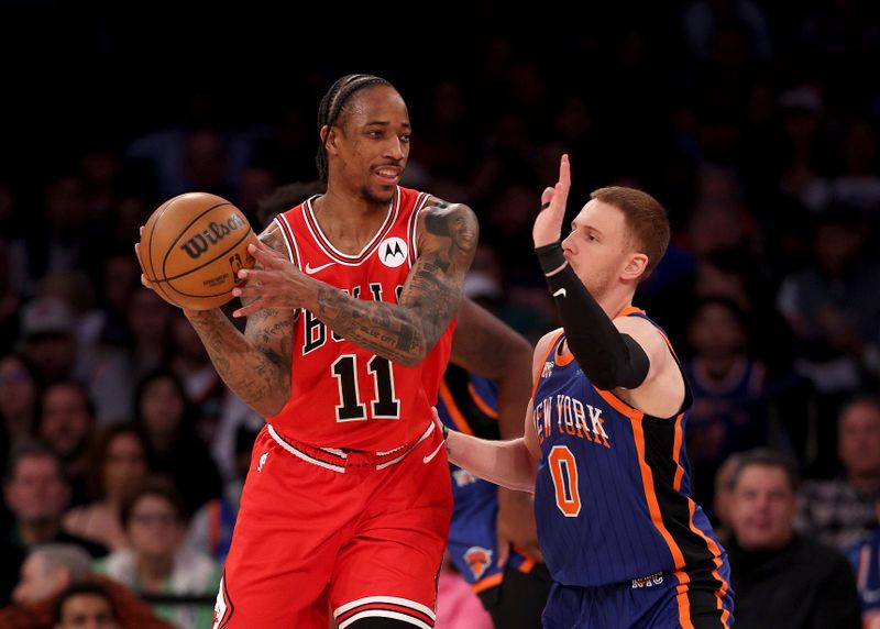 NEW YORK, NEW YORK - APRIL 14: DeMar DeRozan #11 of the Chicago Bulls tries to pass as Donte DiVincenzo #0 of the New York Knicks defends during the first half at Madison Square Garden on April 14, 2024 in New York City. NOTE TO USER: User expressly acknowledges and agrees that, by downloading and or using this photograph, User is consenting to the terms and conditions of the Getty Images License Agreement. (Photo by Elsa/Getty Images)