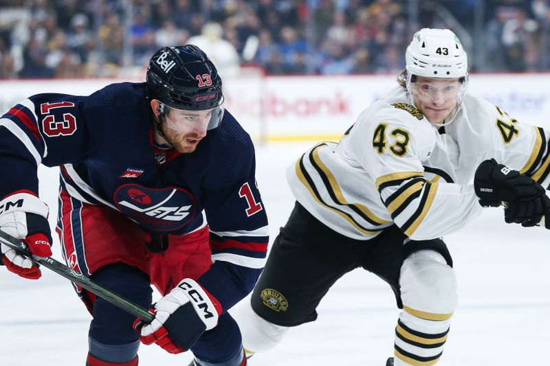 Dec 22, 2023; Winnipeg, Manitoba, CAN;  Winnipeg Jets forward Gabriel Vilardi (13) and Boston Bruins forward Danton Heinen (43) skate after the puck during the first period at Canada Life Centre. Mandatory Credit: Terrence Lee-USA TODAY Sports