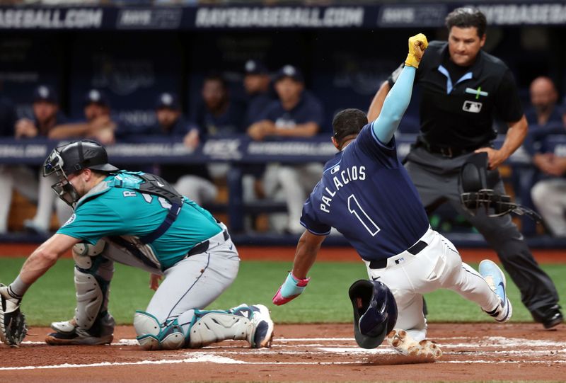 Jun 25, 2024; St. Petersburg, Florida, USA; Tampa Bay Rays outfielder Richie Palacios (1) slides home to score a run as Seattle Mariners catcher Cal Raleigh (29) attempted to tag him out during the second inning at Tropicana Field. Mandatory Credit: Kim Klement Neitzel-USA TODAY Sports