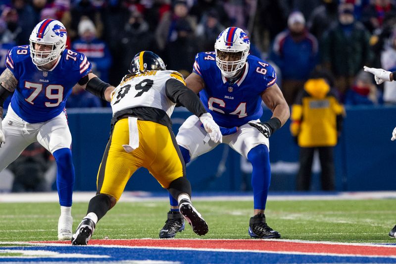 Buffalo Bills guard O'Cyrus Torrence (64) blocks against Pittsburgh Steelers defensive tackle Larry Ogunjobi (99) during an NFL wild-card playoff football game, Monday, Jan. 15, 2024, in Orchard Park, NY. (AP Photo/Matt Durisko)