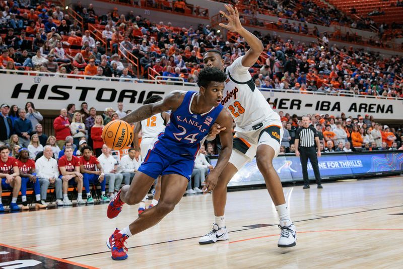 Jan 16, 2024; Stillwater, Oklahoma, USA; Kansas Jayhawks forward K.J. Adams Jr. (24) drives under Oklahoma State Cowboys center Brandon Garrison (23) during the second half at Gallagher-Iba Arena. Mandatory Credit: William Purnell-USA TODAY Sports