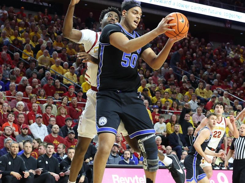 Mar 6, 2024; Ames, Iowa, USA; Brigham Young Cougars center Aly Khalifa (50) gets a rebound in front of Iowa State Cyclones forward Tre King (0) at James H. Hilton Coliseum. Mandatory Credit: Reese Strickland-USA TODAY Sports

