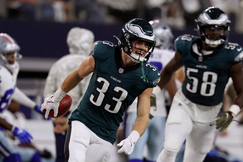 Philadelphia Eagles' Cooper DeJean (33) and Jalyx Hunt (58) celebrate a long punt return by DeJean in the second half of an NFL football game against the Dallas Cowboys in Arlington, Texas, Sunday, Nov. 10, 2024. (AP Photo/Gareth Patterson)