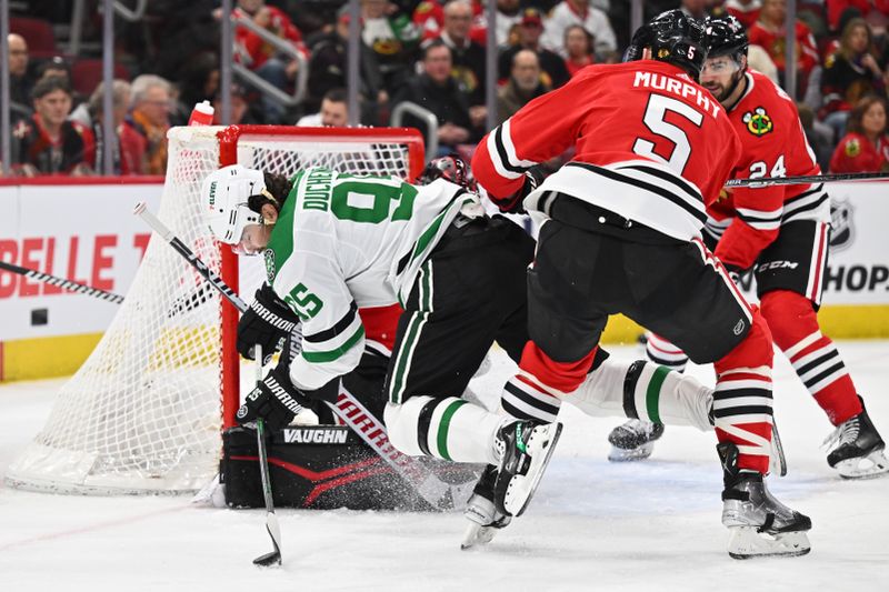 Jan 13, 2024; Chicago, Illinois, USA;  Dallas Stars forward Matt Duchene (95) is knocked off his skates by Chicago Blackhawks defenseman Connor Murphy (5) in the second period at United Center. Mandatory Credit: Jamie Sabau-USA TODAY Sports