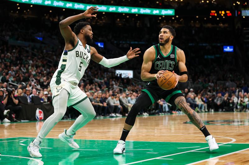 BOSTON, MA - MARCH 20:  Jayson Tatum #0 of the Boston Celtics shoots the ball over Malik Beasley #5 of the Milwaukee Bucks during the fourth quarter of a game at TD Garden on March 20, 2024 in Boston, Massachusetts. NOTE TO USER: User expressly acknowledges and agrees that, by downloading and or using this photograph, User is consenting to the terms and conditions of the Getty Images License Agreement. (Photo by Adam Glanzman/Getty Images)