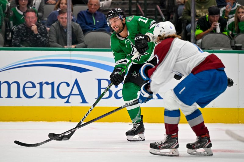 Oct 3, 2022; Dallas, Texas, USA; Dallas Stars center Luke Glendening (11) shoots the puck past Colorado Avalanche defenseman Bowen Byram (4) during the second period at the American Airlines Center. Mandatory Credit: Jerome Miron-USA TODAY Sports