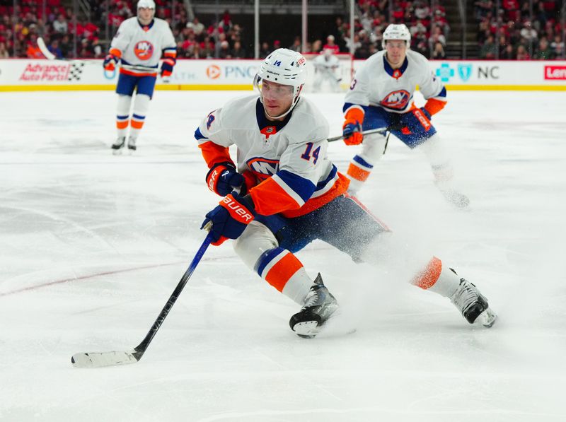 Dec 23, 2023; Raleigh, North Carolina, USA; New York Islanders center Bo Horvat (14) skates with the puck against the Carolina Hurricanes during the second period at PNC Arena. Mandatory Credit: James Guillory-USA TODAY Sports