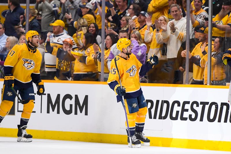 Apr 13, 2024; Nashville, Tennessee, USA; Nashville Predators defenseman Alexandre Carrier (45) celebrates with his teammates after his goal against the Columbus Blue Jackets during the second period at Bridgestone Arena. Mandatory Credit: Steve Roberts-USA TODAY Sports