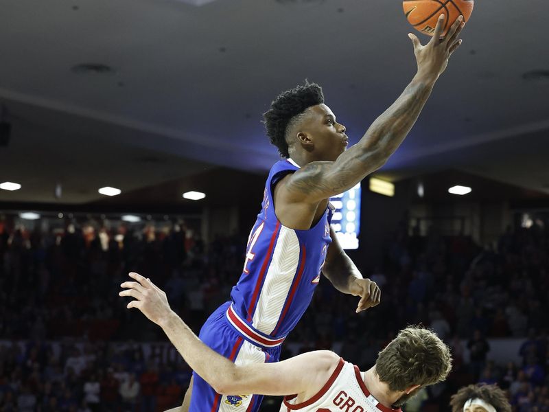 Feb 11, 2023; Norman, Oklahoma, USA; Kansas Jayhawks forward K.J. Adams Jr. (24) goes to the basket over Oklahoma Sooners forward Tanner Groves (35) during the first half at Lloyd Noble Center. Mandatory Credit: Alonzo Adams-USA TODAY Sports