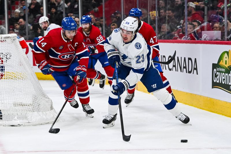 Apr 4, 2024; Montreal, Quebec, CAN; Tampa Bay Lightning center Michael Eyssimont (23) looses control of the puck near Montreal Canadiens center Nick Suzuki (14) during the second period at Bell Centre. Mandatory Credit: David Kirouac-USA TODAY Sports