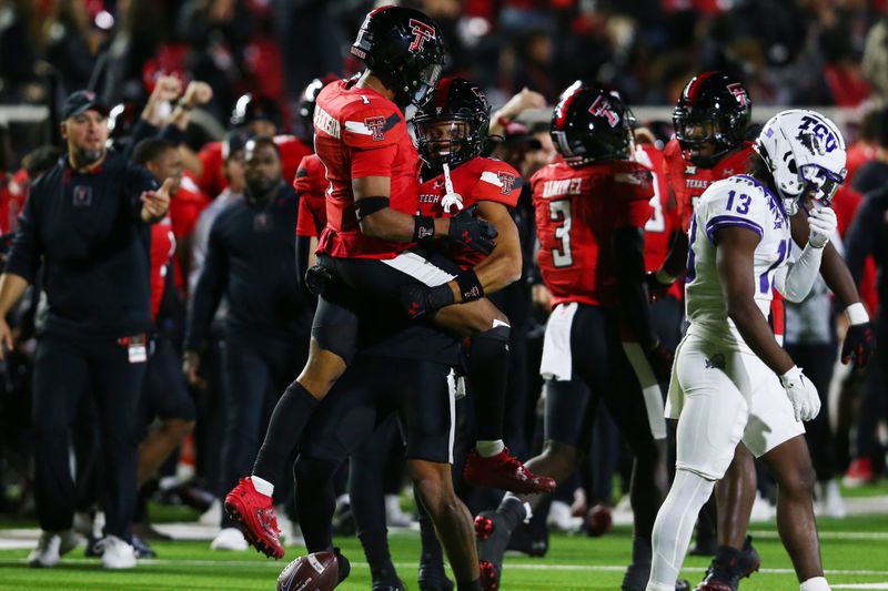 Nov 2, 2023; Lubbock, Texas, USA; Texas Tech Red Raiders defensive safety Darion Taylor-Demerson (1) reacts with defensive back CJ Baskerville (9) after making an interception to end the game as Texas Christian Horned Frogs wide receiver Jaylon Robinson (13) leave the field at Jones AT&T Stadium and Cody Campbell Field. Mandatory Credit: Michael C. Johnson-USA TODAY Sports