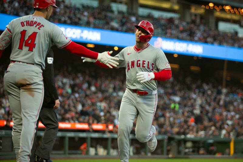 Jun 14, 2024; San Francisco, California, USA; Los Angeles Angels designated hitter Taylor Ward (3) gets a congratulatory handshake from teammate Logan O'Hoppe (14) as he scores on a double by Kevin Pillar during the third inning against the San Francisco Giants at Oracle Park. Mandatory Credit: D. Ross Cameron-USA TODAY Sports