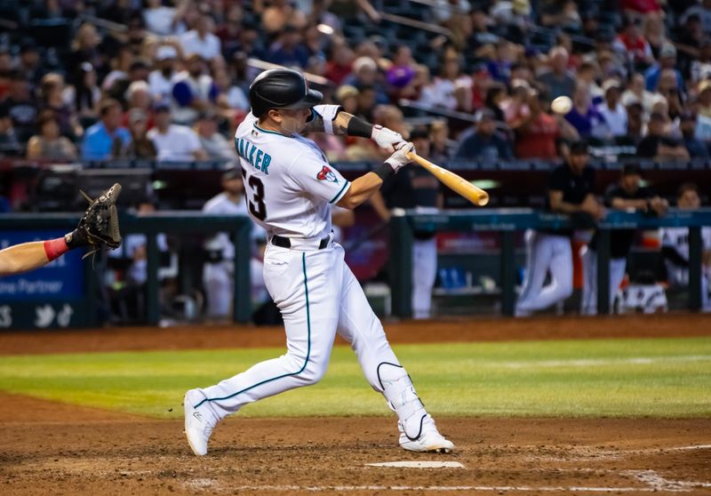 Aug 27, 2023; Phoenix, Arizona, USA; Arizona Diamondbacks batter Christian Walker hits an eighth inning sacrifice fly ball to drive in a run against the Cincinnati Reds at Chase Field. Mandatory Credit: Mark J. Rebilas-USA TODAY Sports