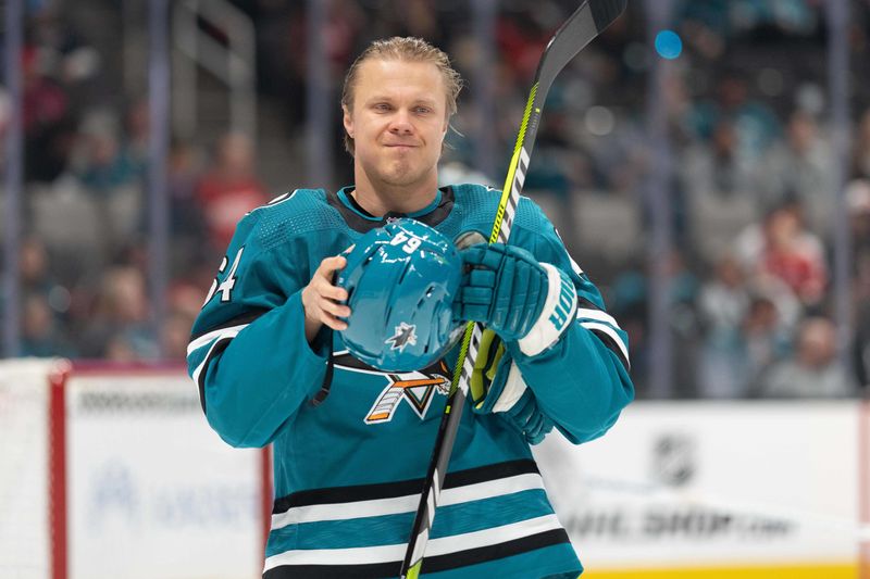 Jan 2, 2024; San Jose, California, USA; San Jose Sharks center Mikael Granlund (64) adjusts his helmet during the first period against the Detroit Red Wings at SAP Center at San Jose. Mandatory Credit: Stan Szeto-USA TODAY Sports