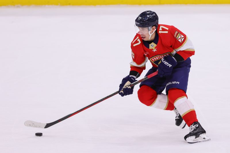 Apr 9, 2024; Sunrise, Florida, USA; Florida Panthers center Evan Rodrigues (17) moves the puck against the Ottawa Senators during the third period at Amerant Bank Arena. Mandatory Credit: Sam Navarro-USA TODAY Sports