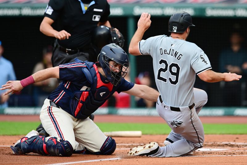 Jul 2, 2024; Cleveland, Ohio, USA; Chicago White Sox shortstop Paul DeJong (29) is tagged out by Cleveland Guardians catcher Austin Hedges (27) during the second inning at Progressive Field. Mandatory Credit: Ken Blaze-USA TODAY Sports