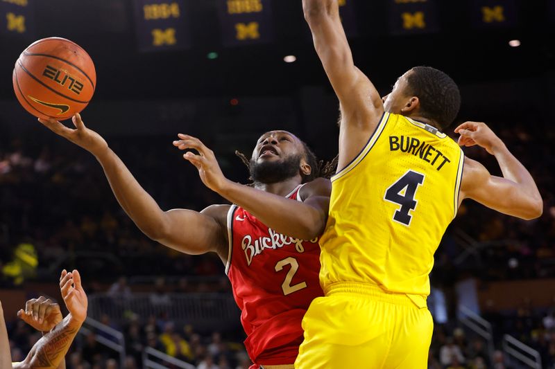 Jan 15, 2024; Ann Arbor, Michigan, USA; Ohio State Buckeyes guard Bruce Thornton (2) shoots around Michigan Wolverines guard Nimari Burnett (4) in the second half at Crisler Center. Mandatory Credit: Rick Osentoski-USA TODAY Sports