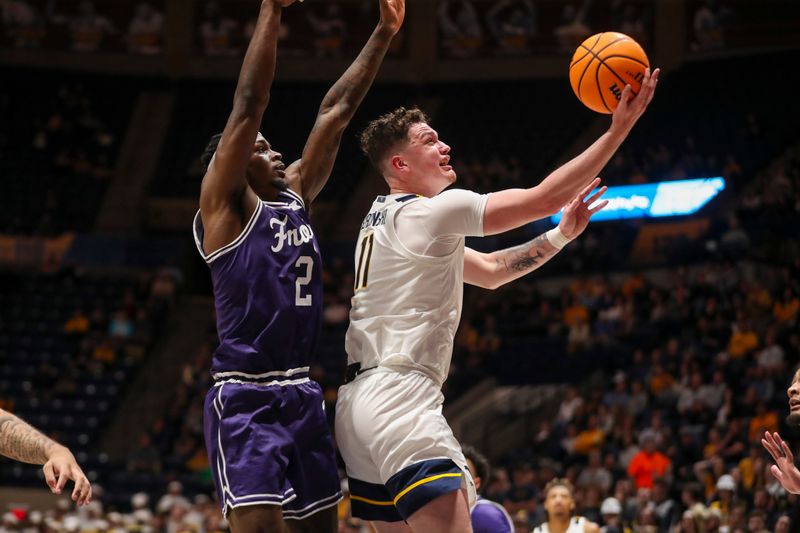 Mar 6, 2024; Morgantown, West Virginia, USA; West Virginia Mountaineers forward Quinn Slazinski (11) shoots against TCU Horned Frogs forward Emanuel Miller (2) during the second half at WVU Coliseum. Mandatory Credit: Ben Queen-USA TODAY Sports