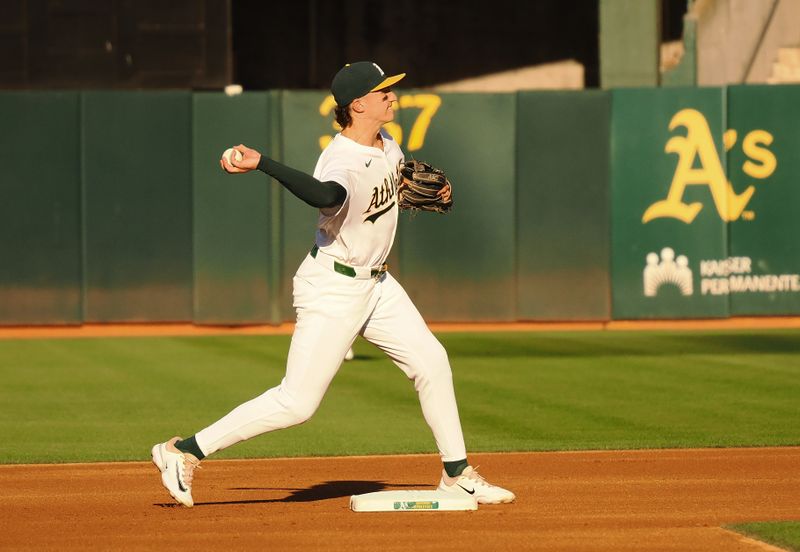 Jul 22, 2024; Oakland, California, USA; Oakland Athletics second baseman Zack Gelof (20) turns double play against the Houston Astros during the first inning at Oakland-Alameda County Coliseum. Mandatory Credit: Kelley L Cox-USA TODAY Sports