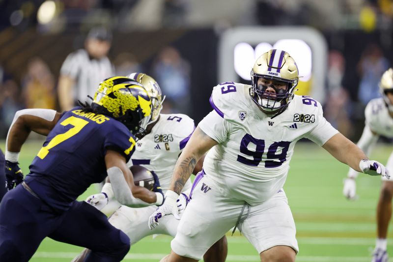 Jan 8, 2024; Houston, TX, USA; Washington Huskies defensive lineman Faatui Tuitele (99) chases Michigan Wolverines running back Donovan Edwards (7) during the third quarter in the 2024 College Football Playoff national championship game at NRG Stadium. Mandatory Credit: Thomas Shea-USA TODAY Sports