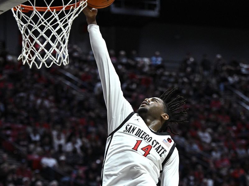 Nov 6, 2023; San Diego, California, USA; San Diego State Aztecs guard Reese Waters (14) goes to the basket during the first half against the Cal State Fullerton Titans at Viejas Arena. Mandatory Credit: Orlando Ramirez-USA TODAY Sports