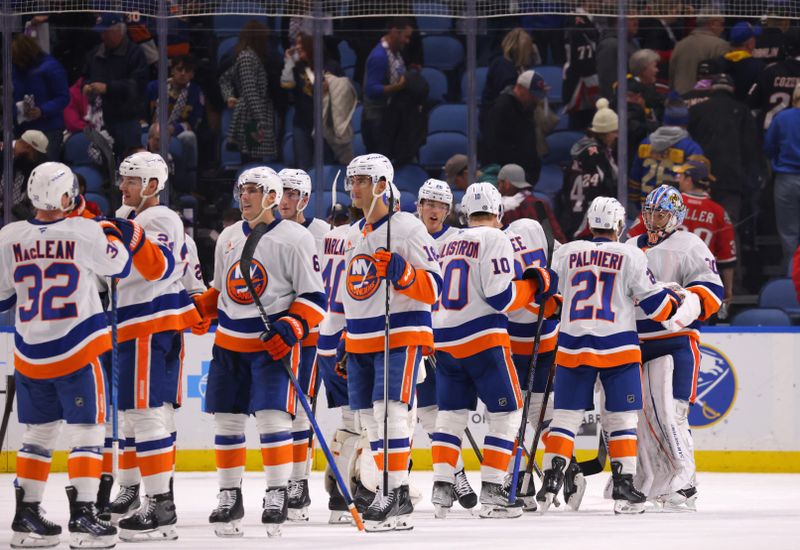 Nov 1, 2024; Buffalo, New York, USA;  The New York Islanders celebrate a win over the Buffalo Sabres at KeyBank Center. Mandatory Credit: Timothy T. Ludwig-Imagn Images