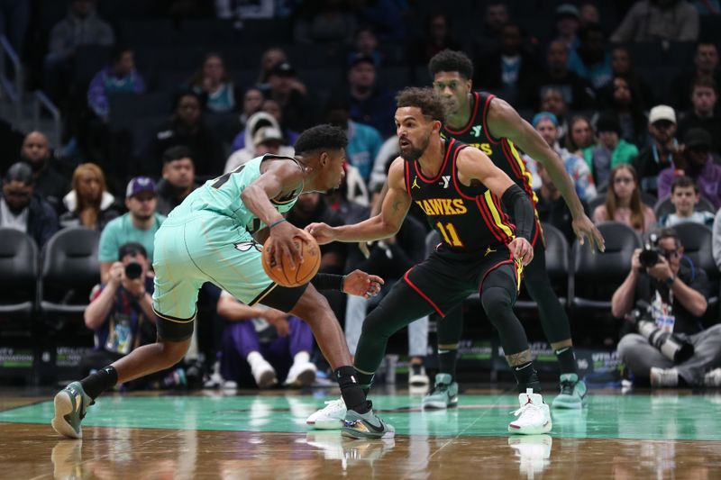 CHARLOTTE, NC - NOVEMBER 30: Trae Young #11 of the Atlanta Hawks plays defense during the game against the Charlotte Hornets on November 30, 2024 at Spectrum Center in Charlotte, North Carolina. NOTE TO USER: User expressly acknowledges and agrees that, by downloading and or using this photograph, User is consenting to the terms and conditions of the Getty Images License Agreement. Mandatory Copyright Notice: Copyright 2024 NBAE (Photo by Brock Williams-Smith/NBAE via Getty Images)