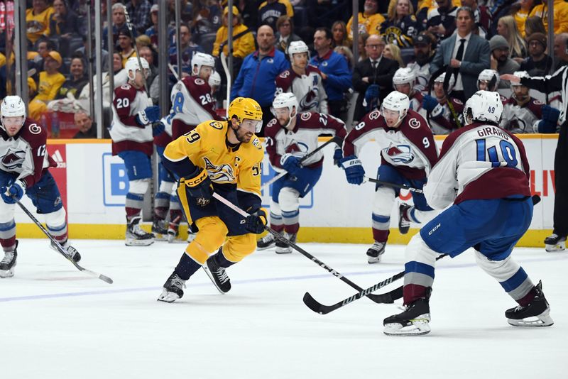 Mar 2, 2024; Nashville, Tennessee, USA; Nashville Predators defenseman Roman Josi (59) skates the puck into the offensive zone during the third period against the Colorado Avalanche at Bridgestone Arena. Mandatory Credit: Christopher Hanewinckel-USA TODAY Sports