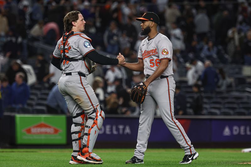 Sep 24, 2024; Bronx, New York, USA; Baltimore Orioles relief pitcher Seranthony Dominguez (56) and catcher Adley Rutschman (35) celebrates after deating the New York Yankees at Yankee Stadium. Mandatory Credit: Vincent Carchietta-Imagn Images