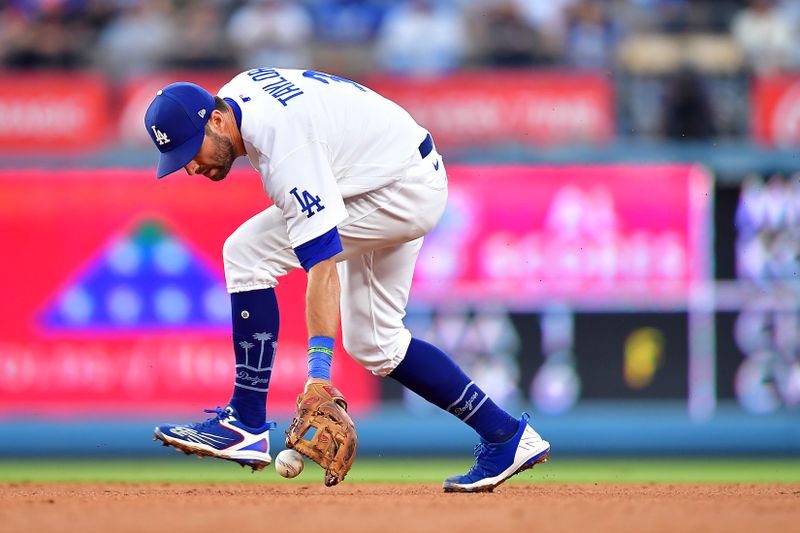 Jul 29, 2023; Los Angeles, California, USA; Los Angeles Dodgers second baseman Chris Taylor (3) mishandles the single of Cincinnati Reds center fielder TJ Friedl (29) during the sixth inning at Dodger Stadium. Mandatory Credit: Gary A. Vasquez-USA TODAY Sports