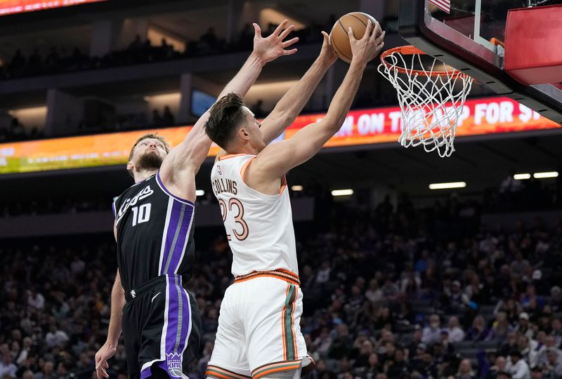 SACRAMENTO, CALIFORNIA - MARCH 07: Zach Collins #23 of the San Antonio Spurs goes in for a layup over Domantas Sabonis #10 of the Sacramento Kings during the first half at Golden 1 Center on March 07, 2024 in Sacramento, California. NOTE TO USER: User expressly acknowledges and agrees that, by downloading and or using this photograph, User is consenting to the terms and conditions of the Getty Images License Agreement. (Photo by Thearon W. Henderson/Getty Images)